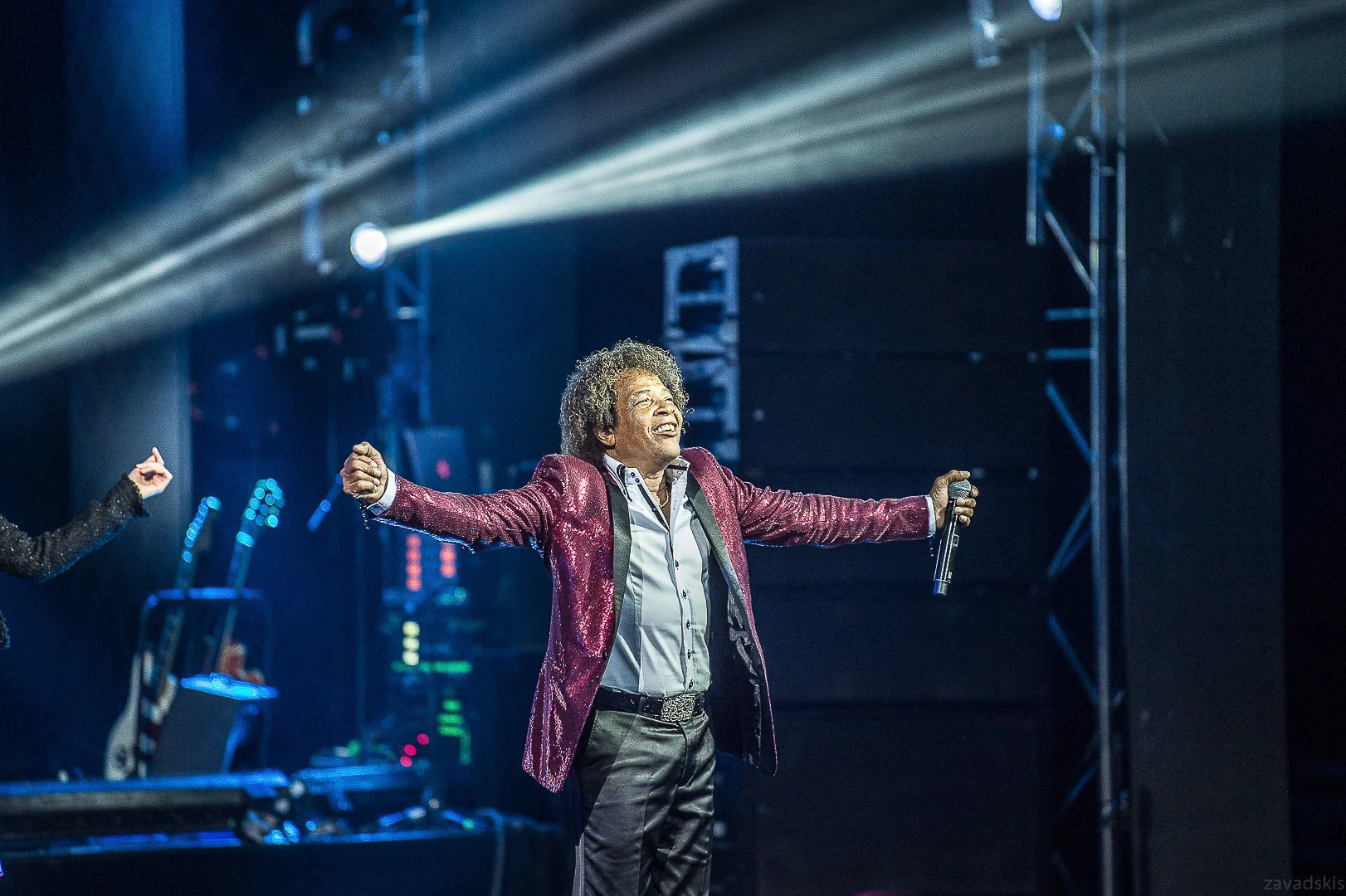 Man in Red Jacket and Trousers on Stage – Event Photography Portfolio