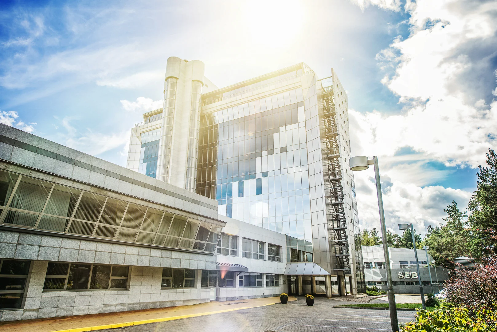 Modern Building with Glass Facade and Green Background – Building Photography