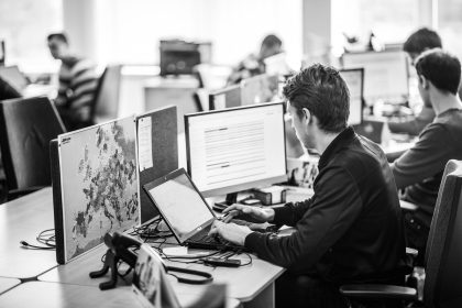 Man Working at a Computer in a Factory – Production Environment Photography
